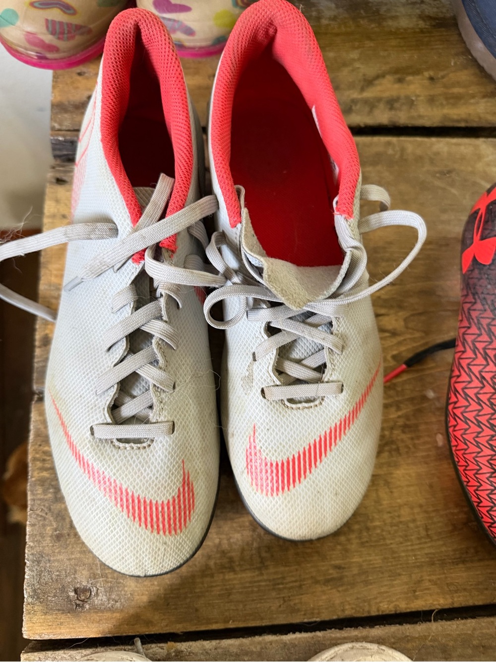 Nike Light Gray Soccer Cleats with Orange Accents